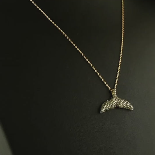 El işçiliğiyle hazırlanan tasarım pırlanta altın kolye, kahverengi pırlantaların parlaklığı ile öne çıkar çünkü taşların her biri dikkatle yerleştirilmiştir. Balık kuyruğu figürüyle minimal tarzı yansıtan bu kahverengi pırlanta kolye, hem günlük kombinlerde hem de özel davetlerde şıklığı artıran nadide bir mücevherdir.