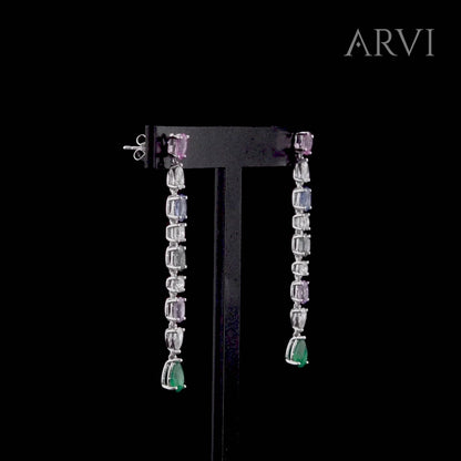 Zümrüt, safir ve pırlantanın büyüleyici birlikteliğiyle tasarlanmış, beyaz altın üzerinde ince işçilikle şekillendirilmiş safir zümrüt pırlanta taşlı küpe. Renk geçişleriyle göz alıcı bir şıklık sunan bu uzun küpe, estetik dokunuşu ile dikkat çeker.

